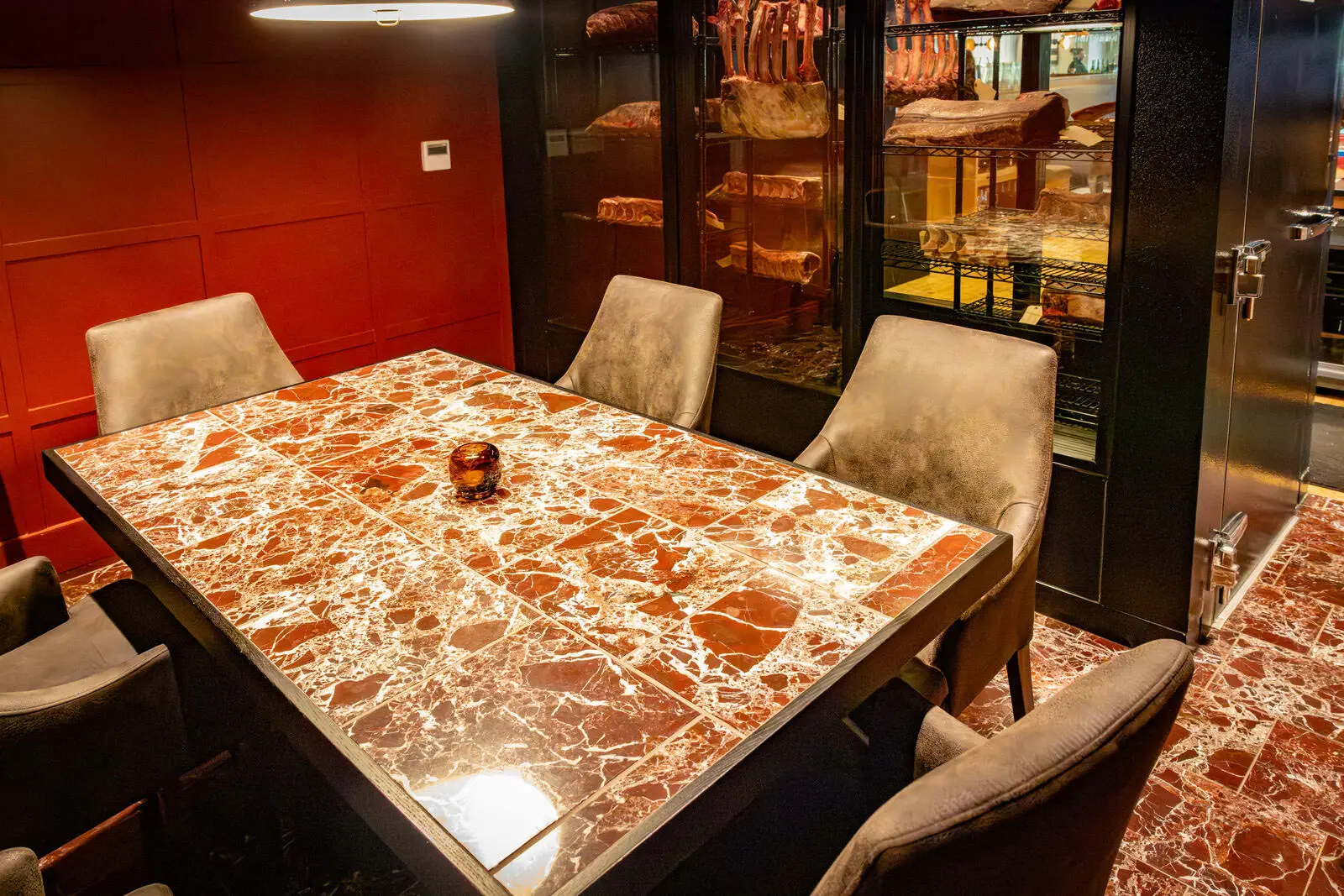 View from the Gangster Room table looking through the dry-aging room glass at Crawford Brothers